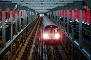 New York City subway car traveling down the tracks and across the Williamsburg Bridge between Brooklyn and Manhattan