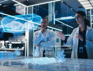 Male And Female Industrial Engineers Using Futuristic Hologram of Wind Turbine Prototype In Computer Powered Modern Laboratory. Multiethnic Colleagues Looking At High-Tech VFX Projection.